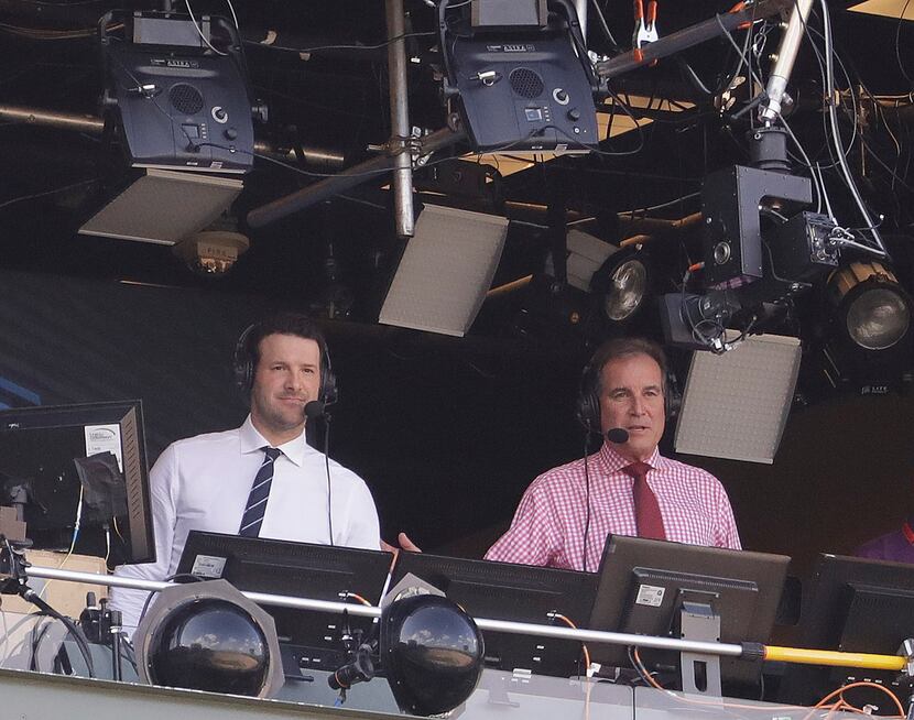 Tony Romo and Jim Nantz are seen in the broadcast boothnbefore an NFL football game between...