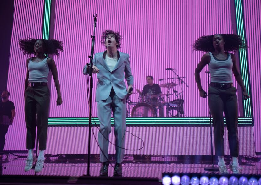 Matt Healy, center, lead singer of The 1975 performs at the Toyota Music Factory in Irving...