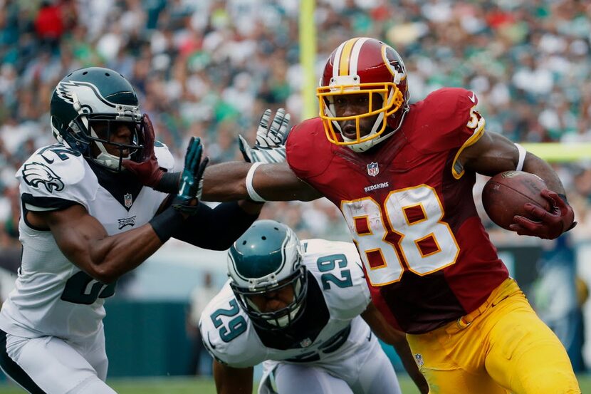 Washington Redskins' Pierre Garcon (88) tries to break a tackle by Washington Redskins'...