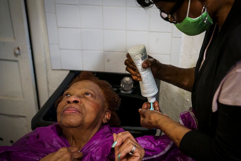 Earnestine Tarrant washes the hair of client Vera Harris at her hair salon in South Dallas...