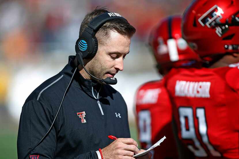 FILE - In this Nov. 18, 2017, file photo, Texas Tech coach Kliff Kingsbury looks down at his...