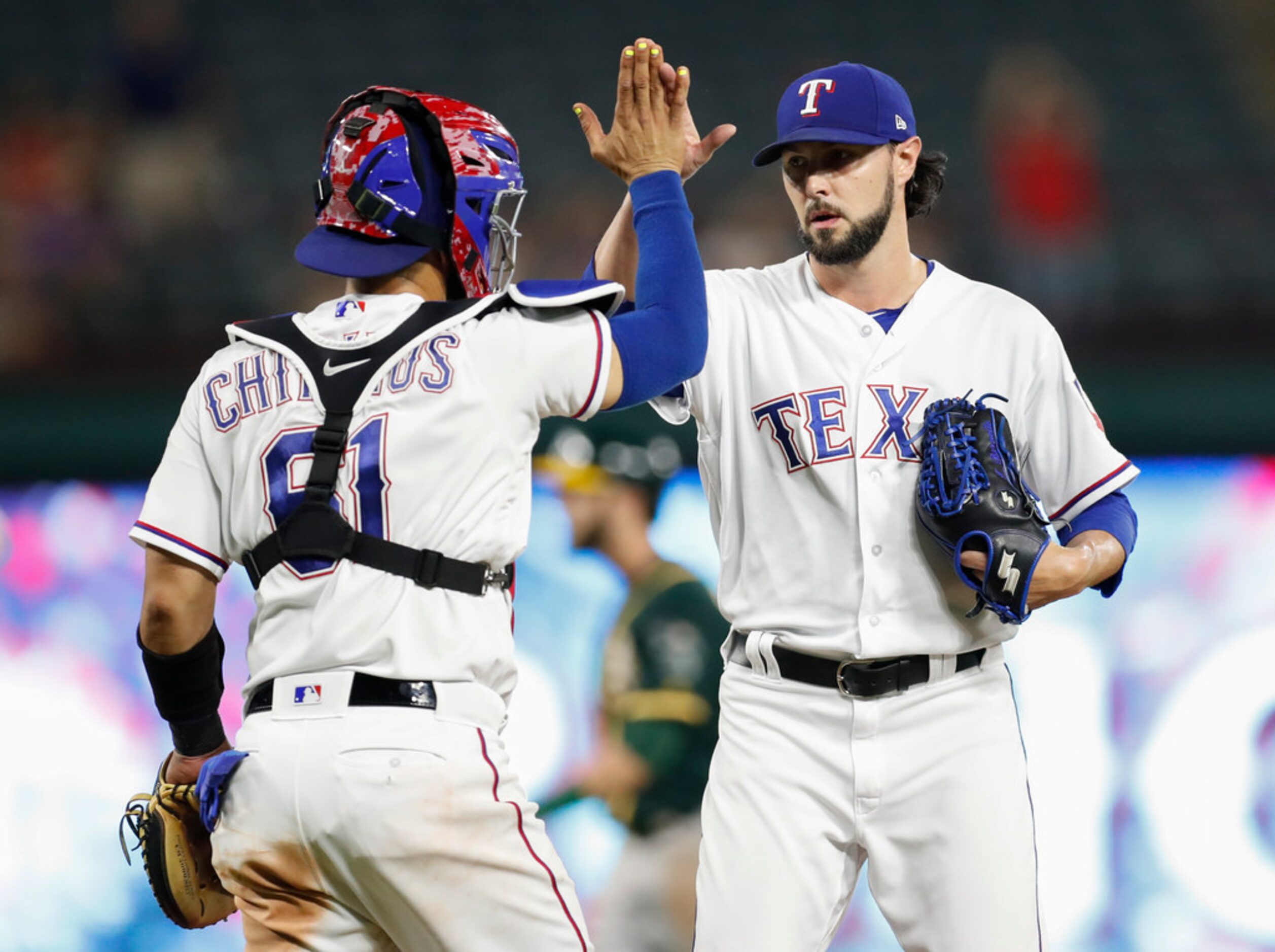 Texas Rangers catcher Robinson Chirinos (61) and Texas Rangers relief pitcher Tony Barnette...