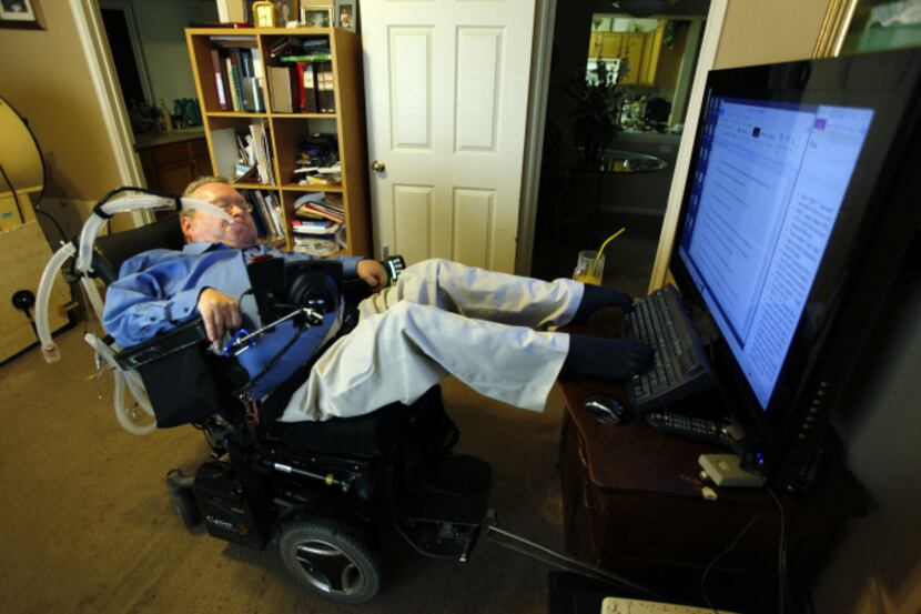 Using his toes to type on his computer, Joe Rowe works on a novel about a modern-day Robin...
