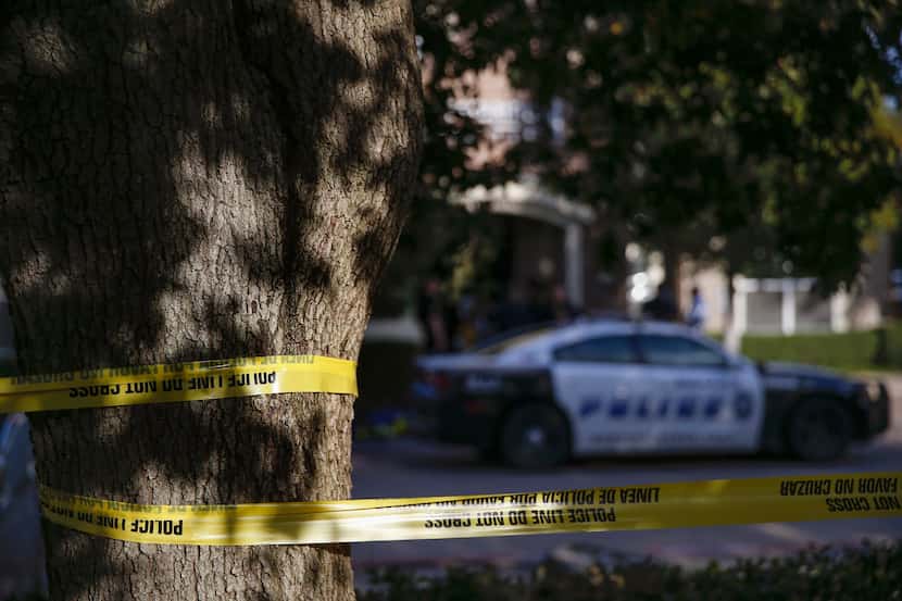Dallas Police investigate where two children and two adults were found shot to death at a...