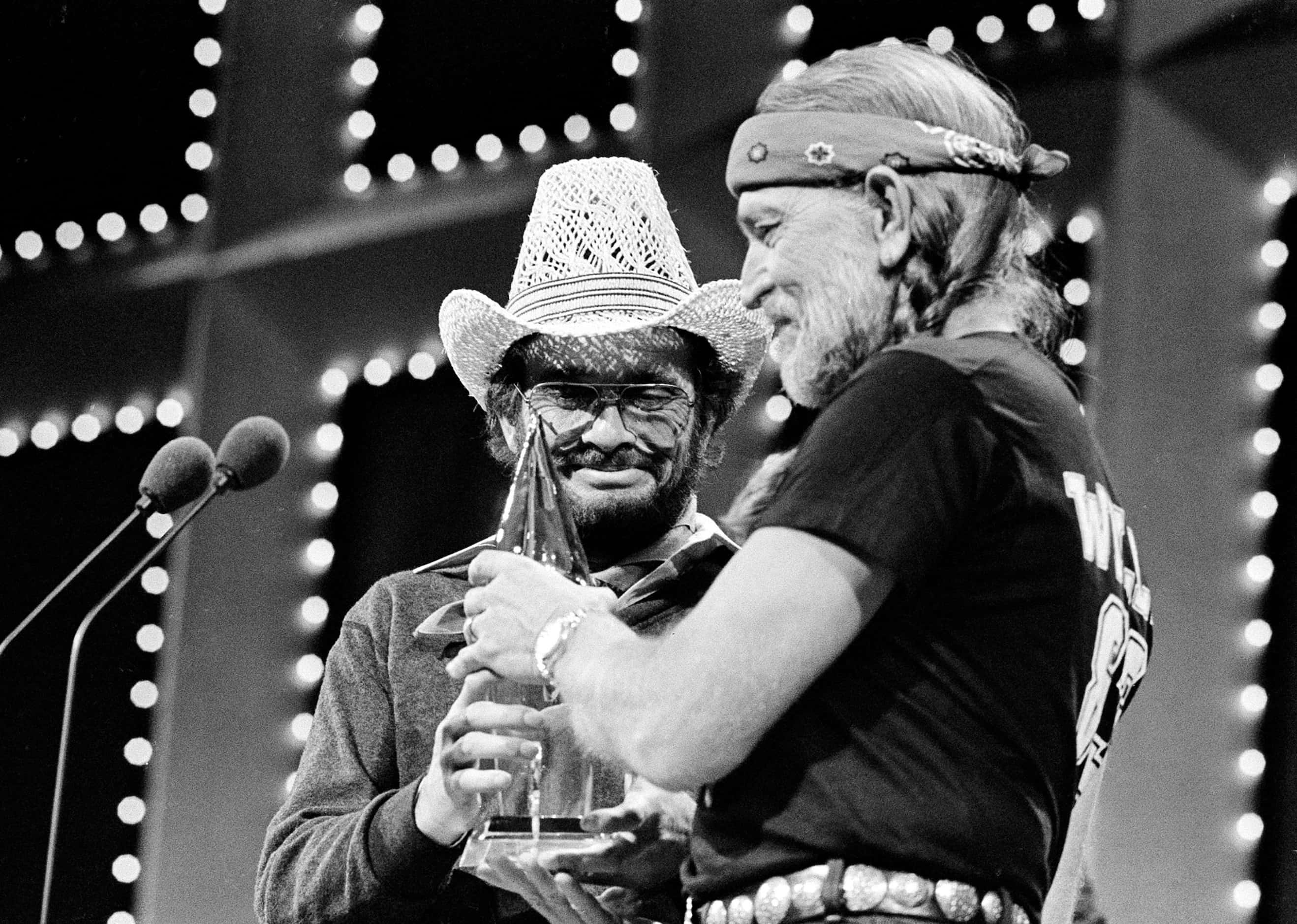 1983 - Merle Haggard, left, and Willie Nelson accept their Duo of the Year award at the...
