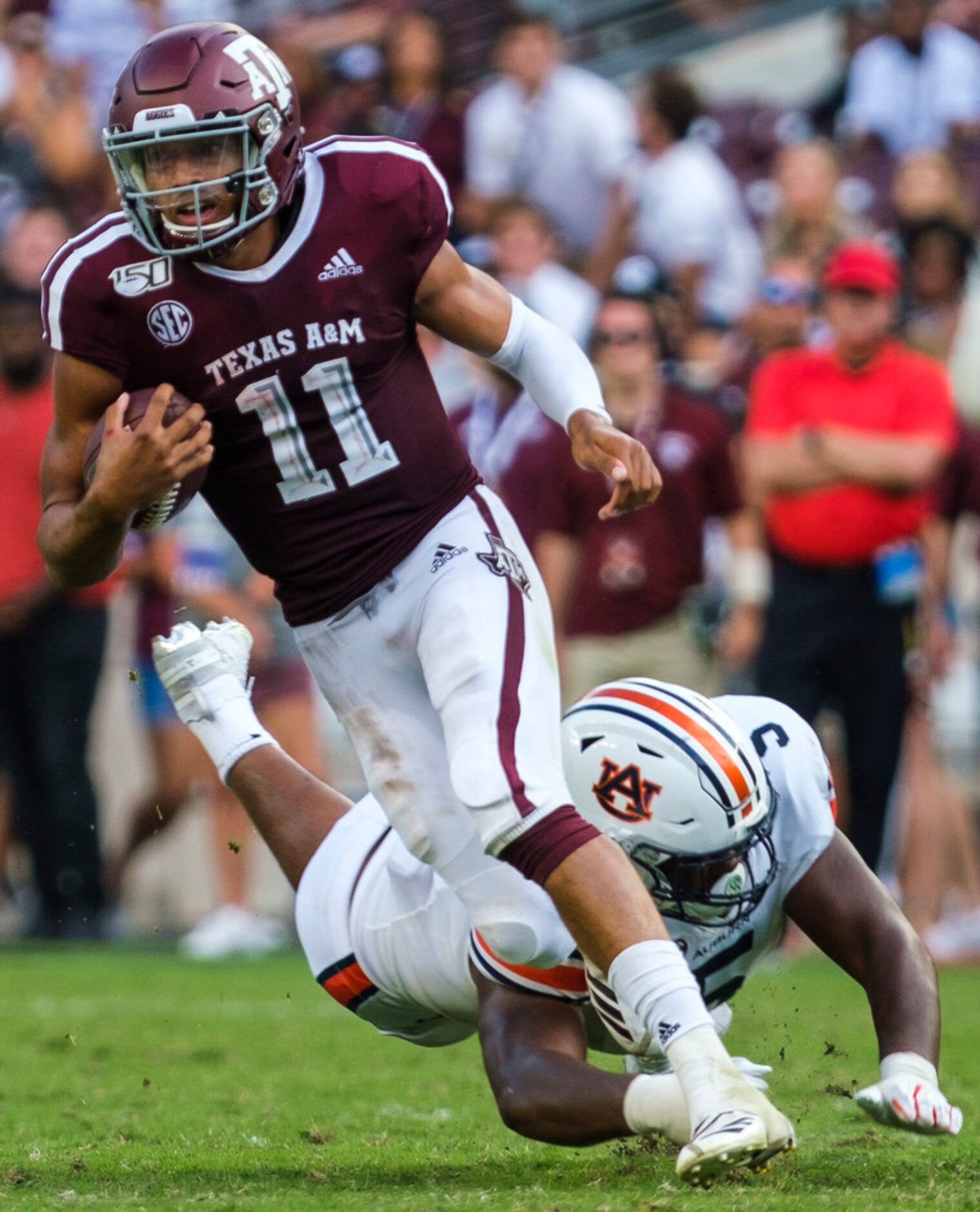 Texas A&M quarterback Kellen Mond (11) slips away from Auburn defensive tackle Derrick Brown...