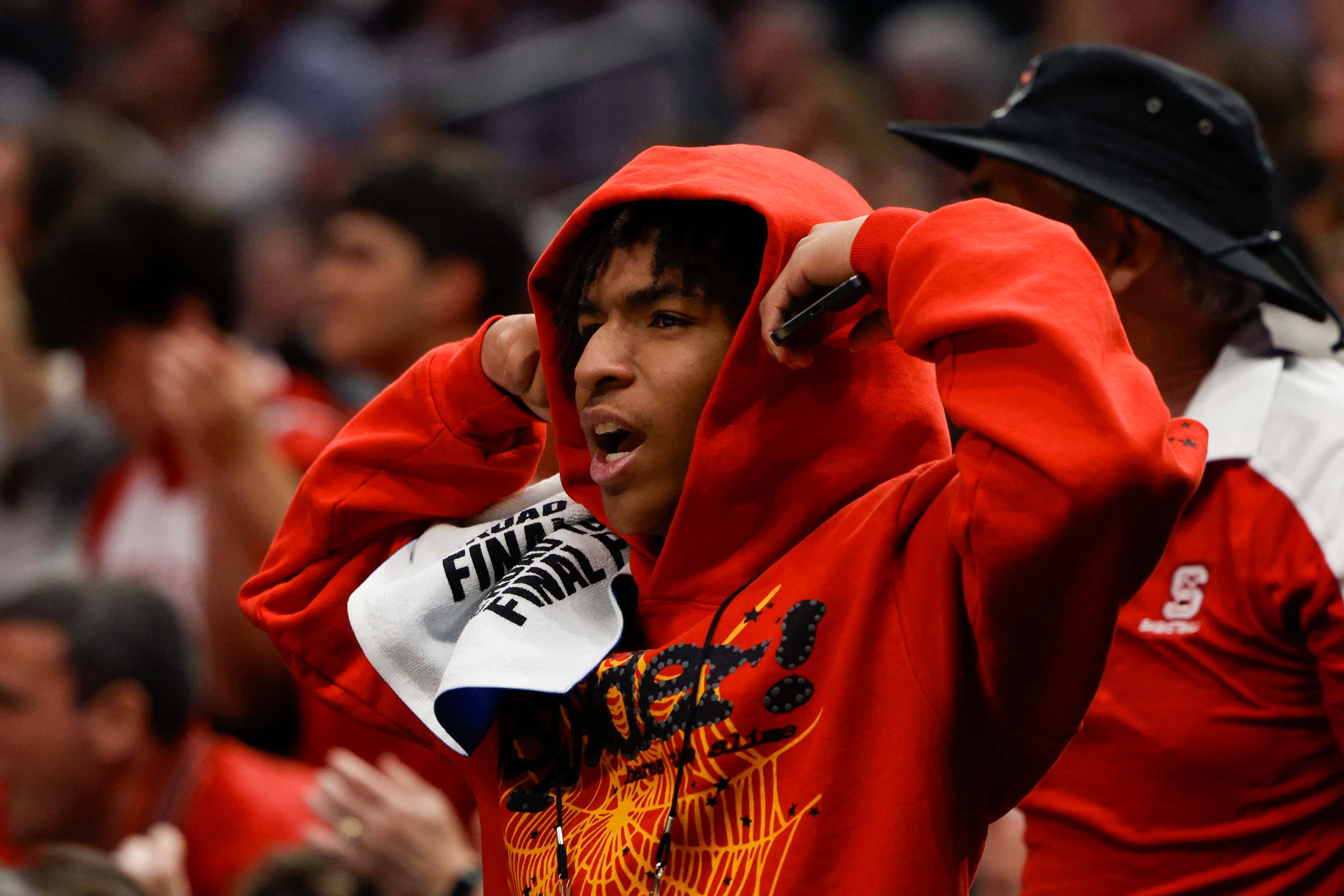 A North Carolina State fan cheers during the second half of an NCAA Men’s Sweet 16...
