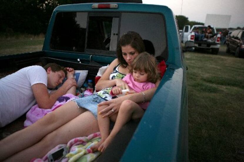  Danny Kinnard sleeps as his wife, Katy Kinnard, and daughter Gracie Kinnard, 3, from...