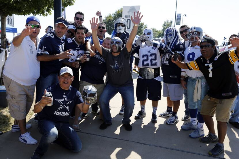Fans party on a street corner near AT&T Stadium before the start of a NFL football game...