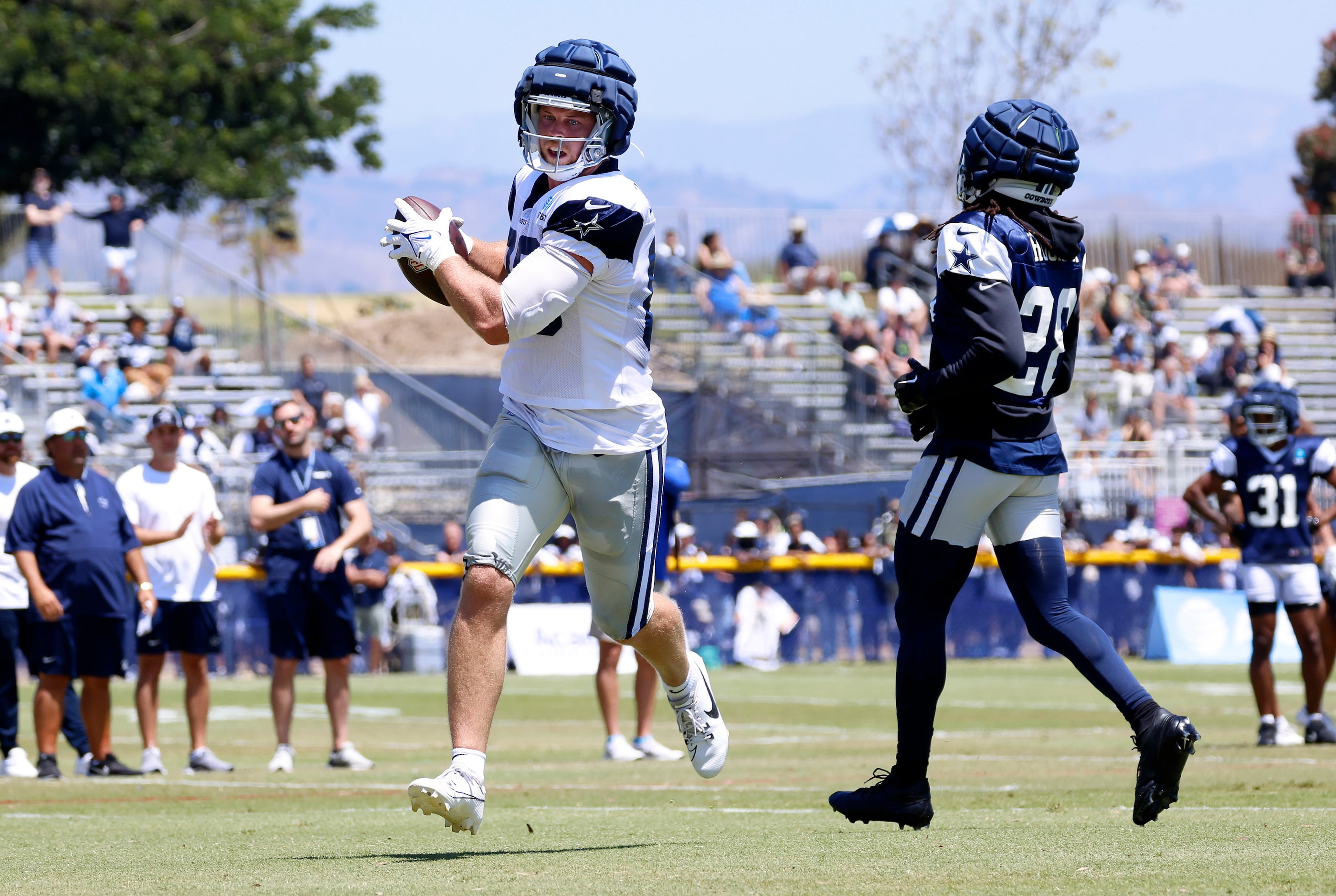 Dallas Cowboys tight end Luke Schoonmaker (86) catches a pass as safety Malik Hooker (28)...