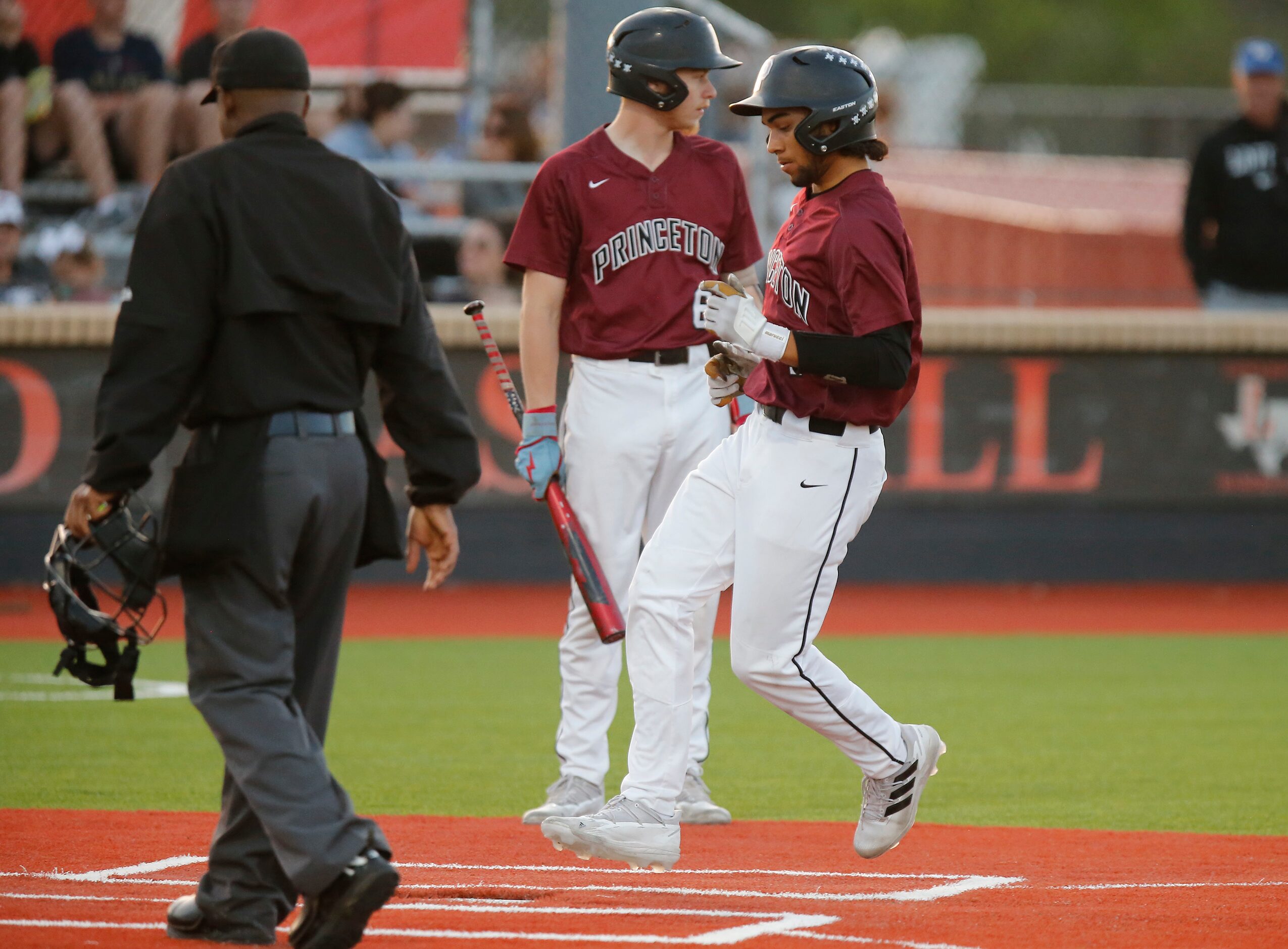 Princeton High School left fielder Andrew Loera (4) scores on a pass ball in the first...