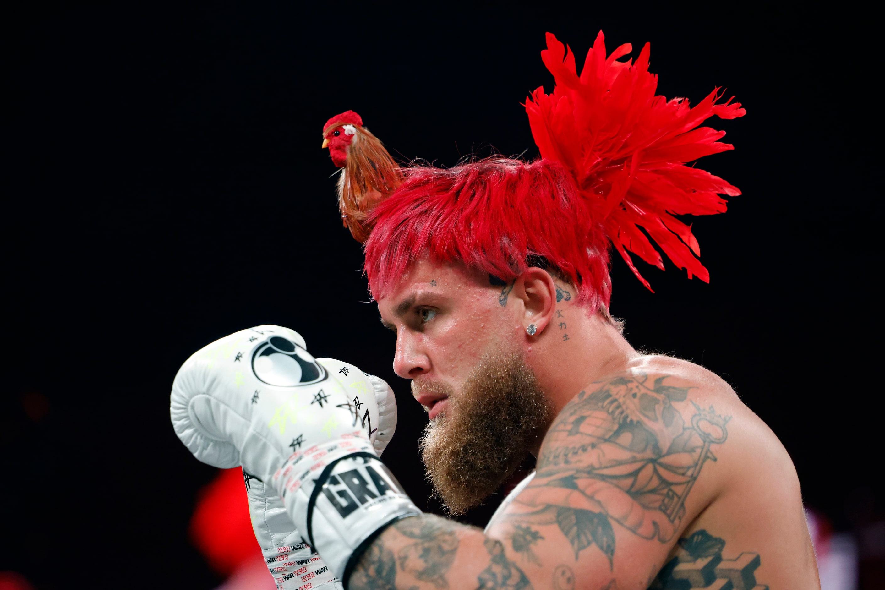 Jake Paul wears a rooster hairpiece during an open workout ahead of his boxing match against...