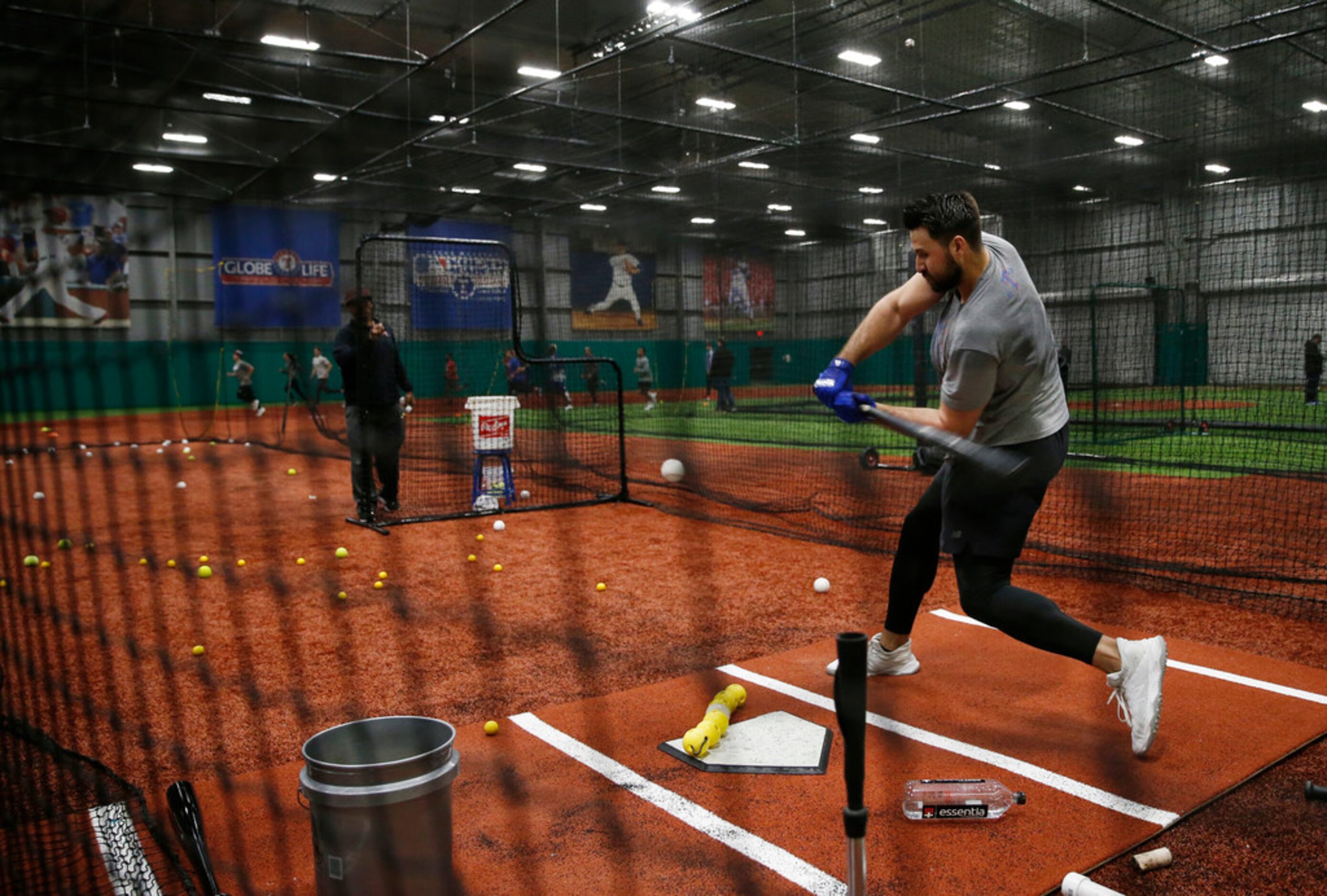 Texas Rangers Joey Gallo (13) works with Texas Rangers hitting coach Luis Ortiz (18) in the...