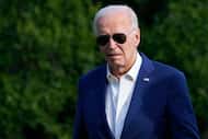President Joe Biden walks across the South Lawn of the White House in Washington, Sunday,...