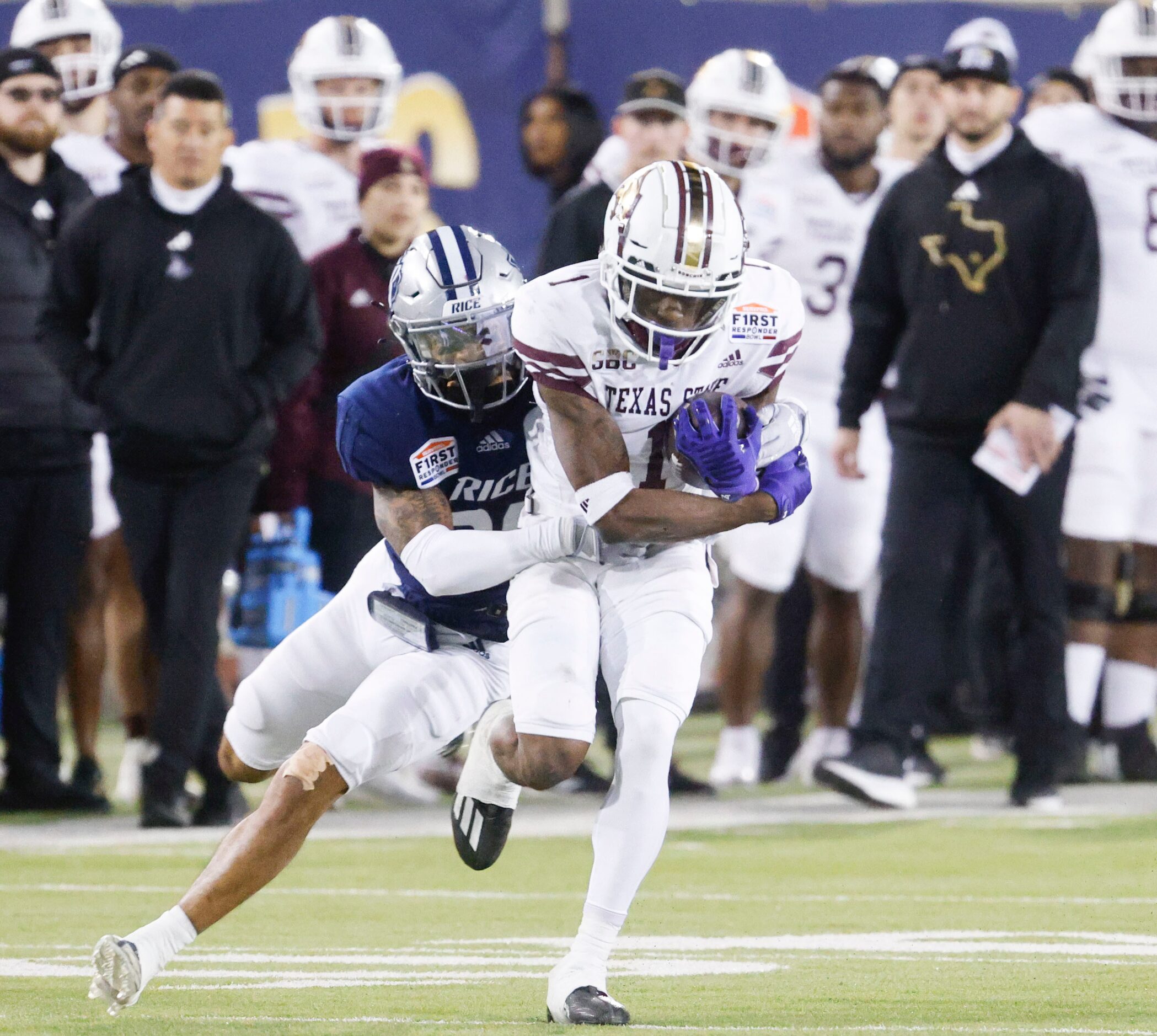 Rice safety Daveon Hook (left) attempts to bring down Texas State wide receiver Ashtyn...