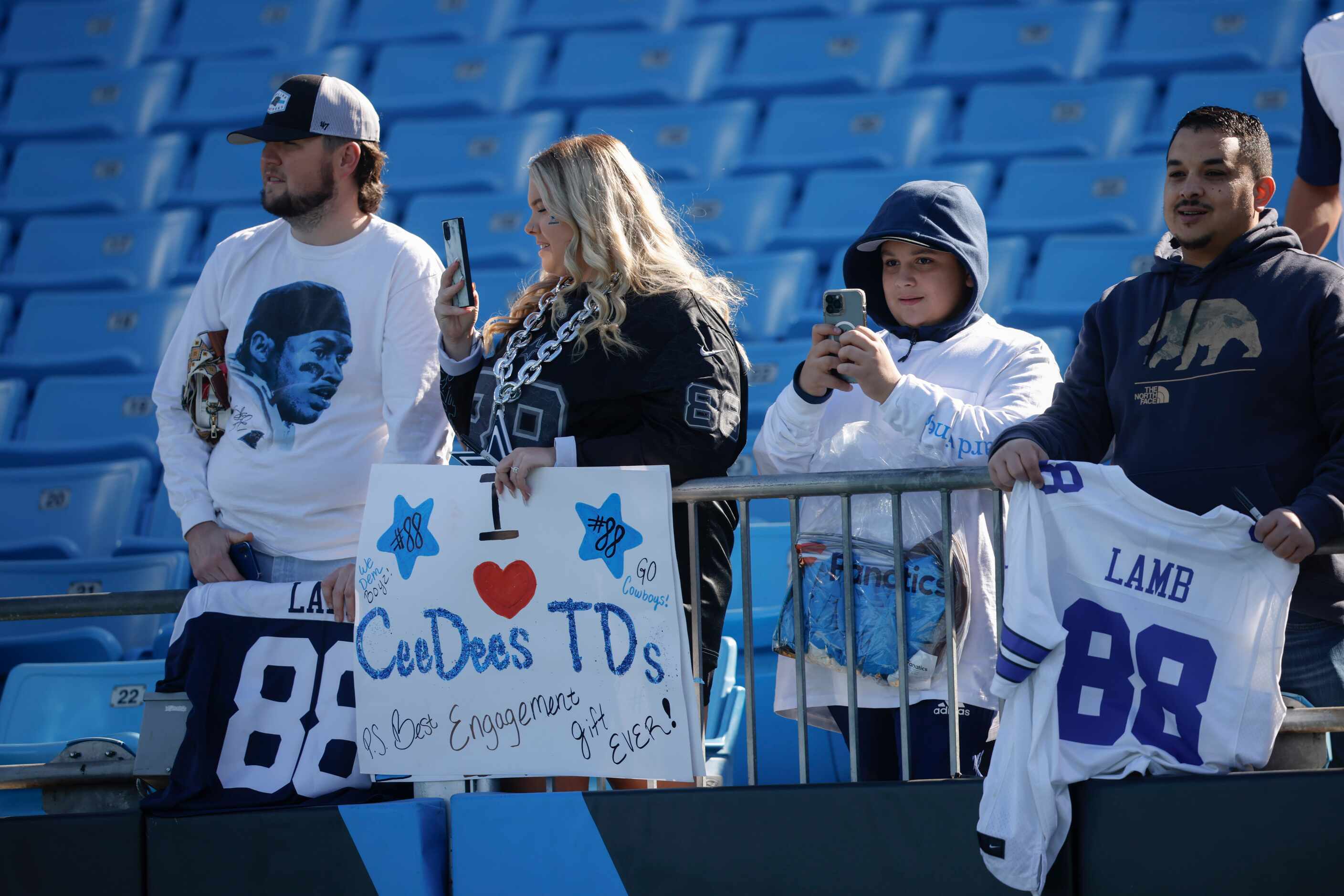 Fans watch Dallas Cowboys during pregame workouts before an NFL game against the Carolina...