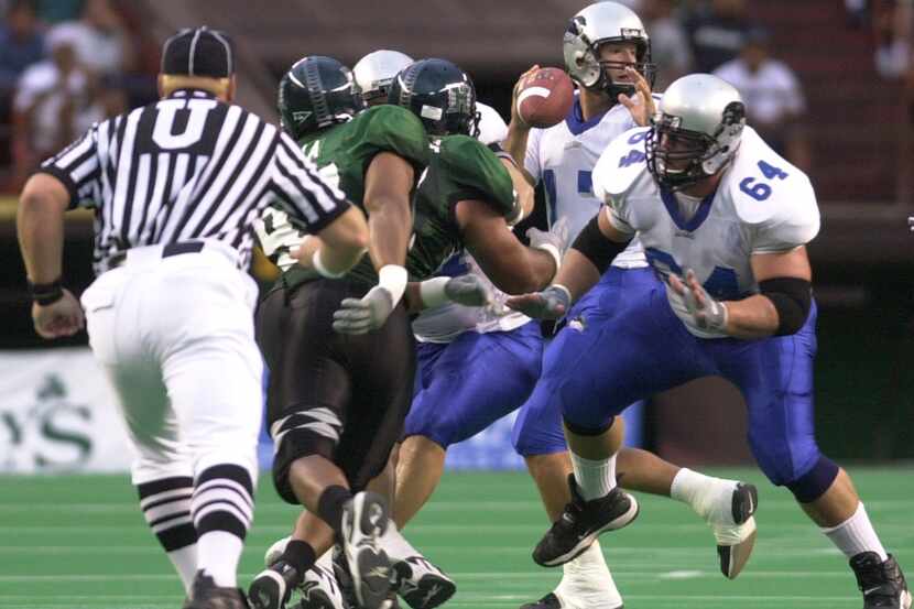 Eastern Illinois quarterback Tony Romo, center, throws from the pocket against Hawaii during...