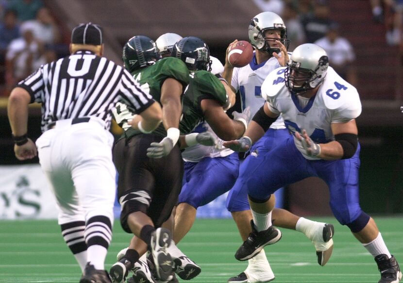 Eastern Illinois quarterback Tony Romo, center, throws from the pocket against Hawaii during...