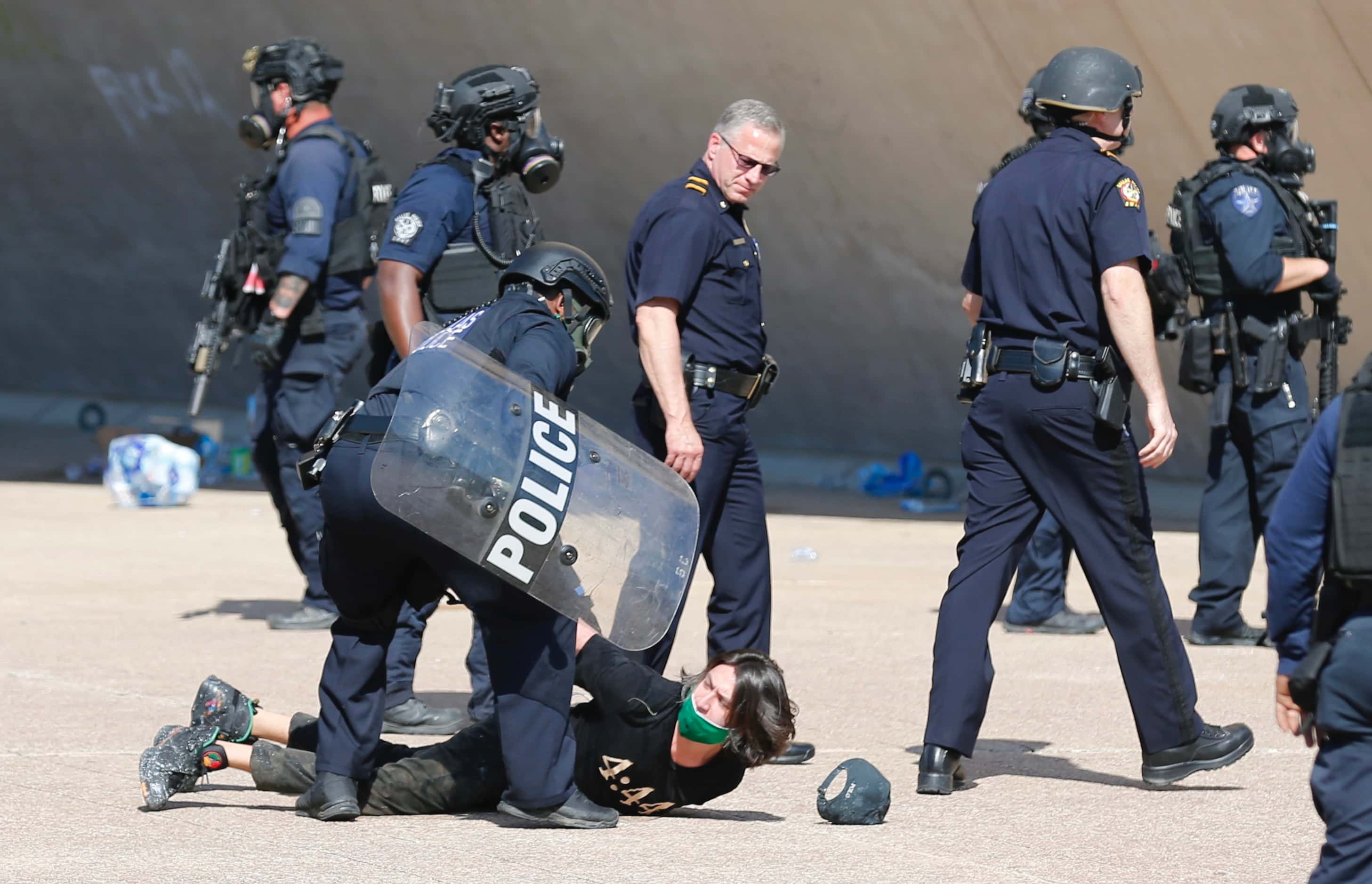 A protester is detained during a demonstration against police brutality in downtown Dallas,...