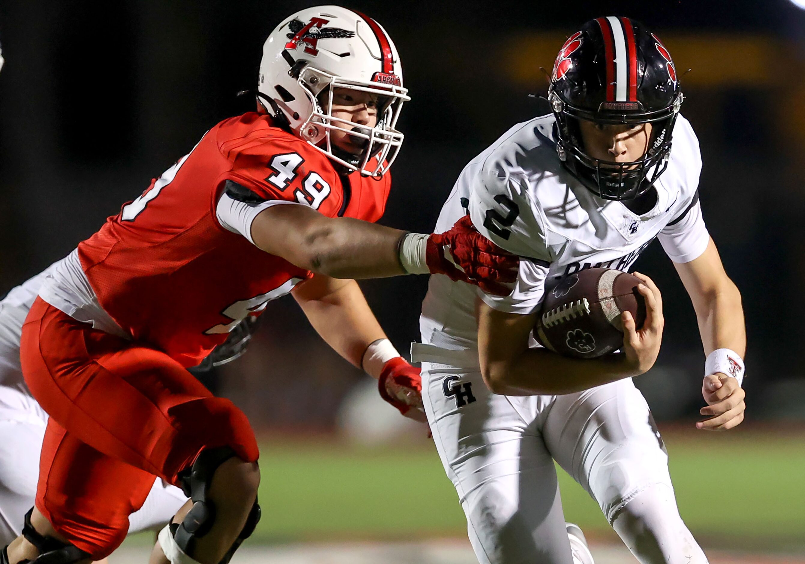 Colleyville Heritage quarterback Bodey Weaver (2) tries to avoid getting sacked by Argyle...