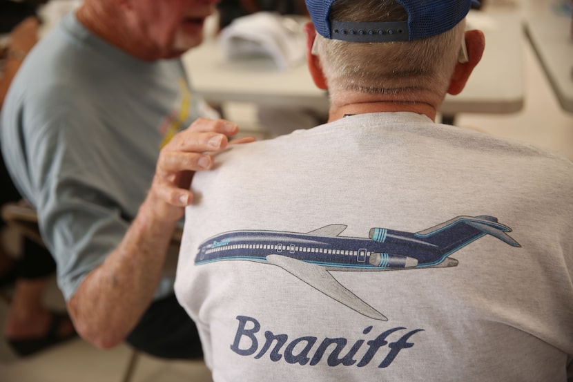 Charlie Monch (left) embraced Dale Eddy as the retired Braniff pilots visited during the...