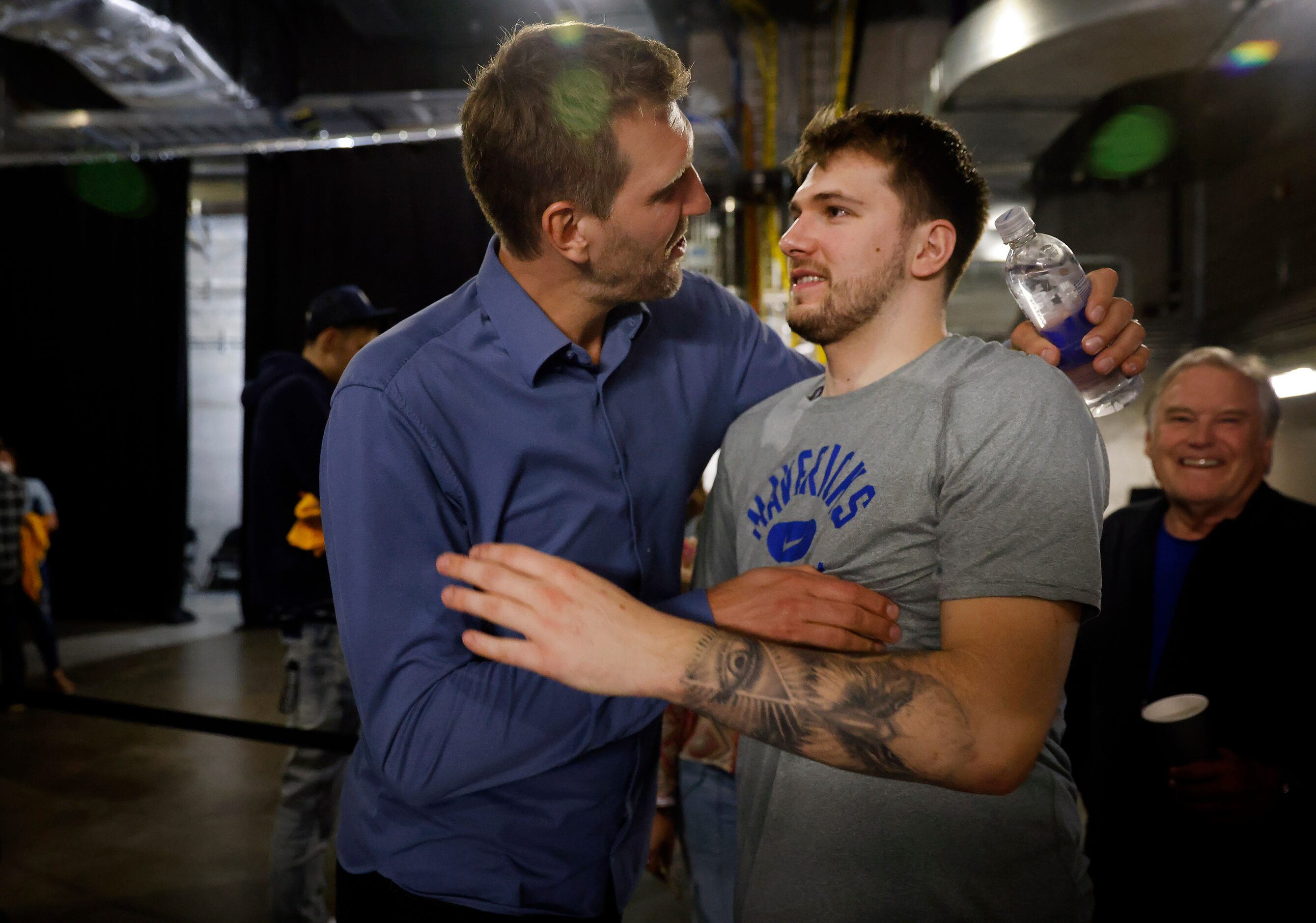 Former Dallas Mavericks forward Dirk Nowitzki congratulates guard Luka Doncic on a good...