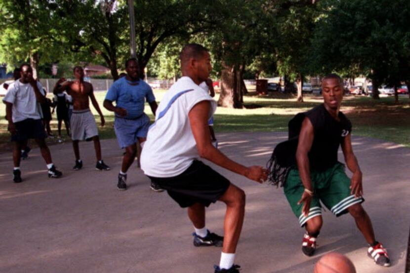 
Marqui Washington (right) is guarded by Dewey Rivers during a pickup basketball game in...