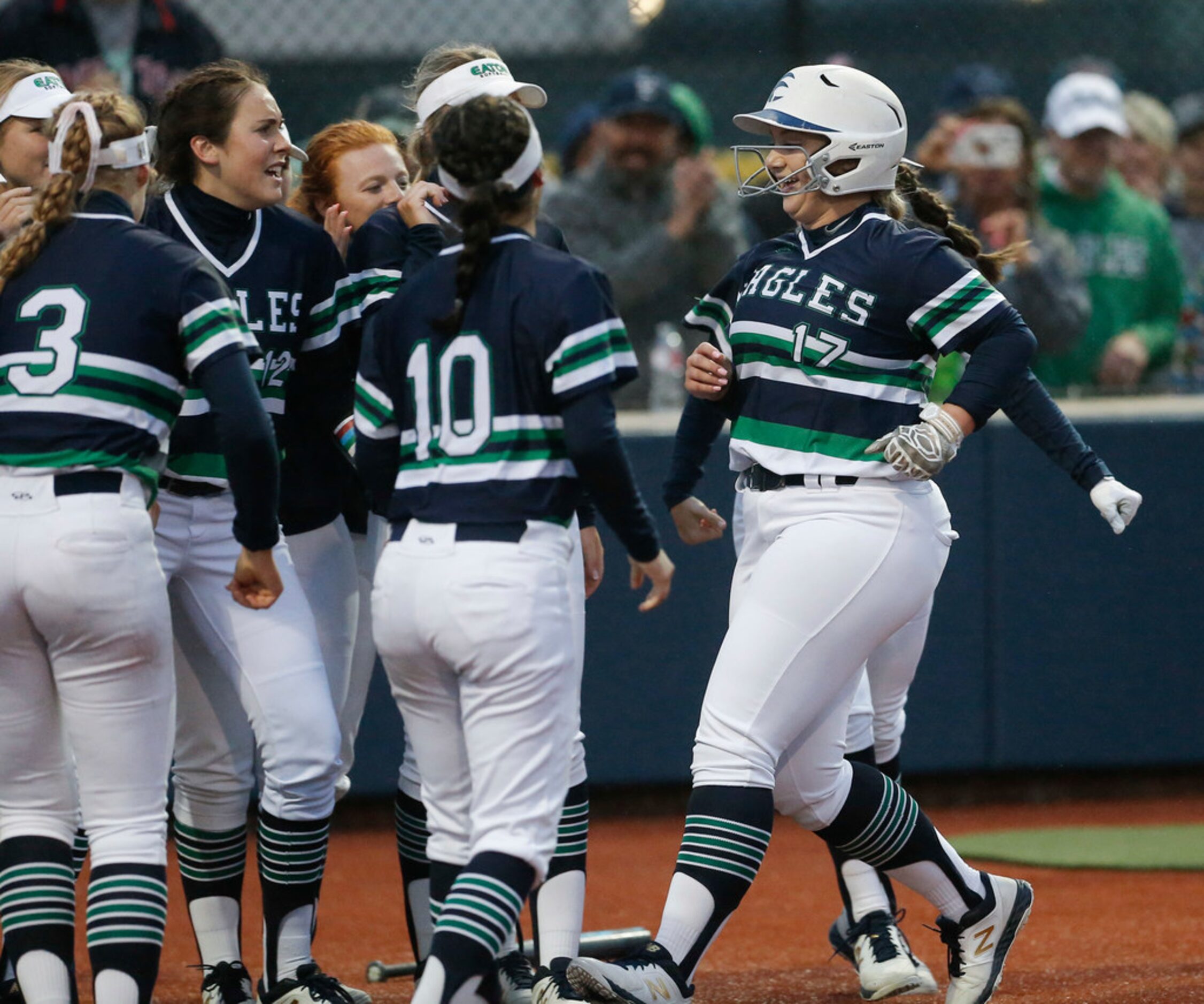 Eaton's Jaden Middlebrook (17) is congratulated by teammates after hitting a solo home run...