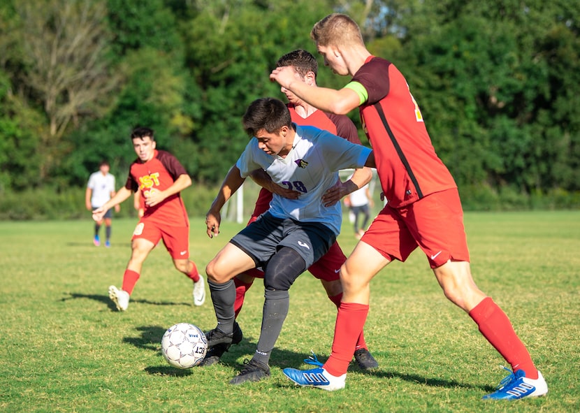 Paul Quinn's #28 Levyn Benavides holds off two defenders.