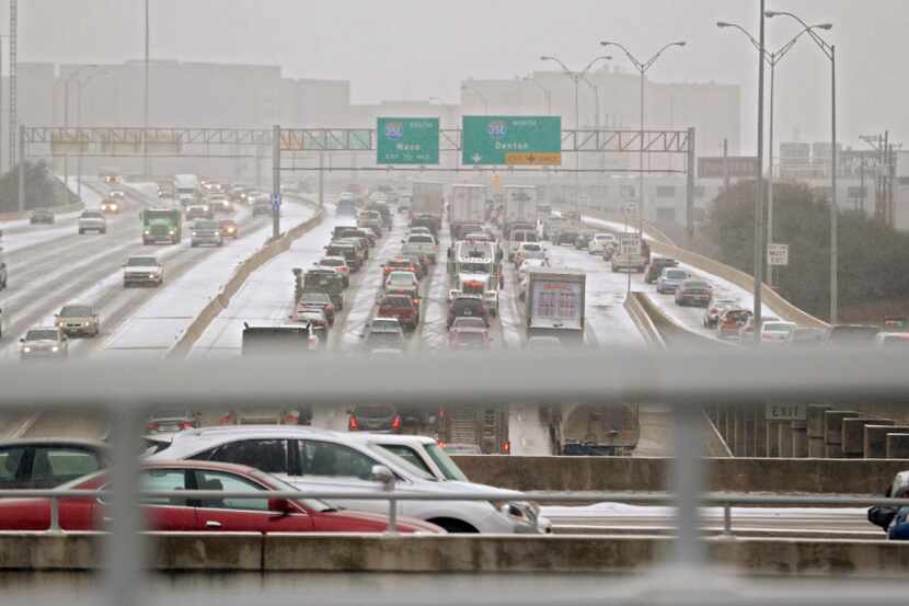 Traffic is snarled in the snow over Woodall Rodgers Frwy in downtown Dallas on January 6,...