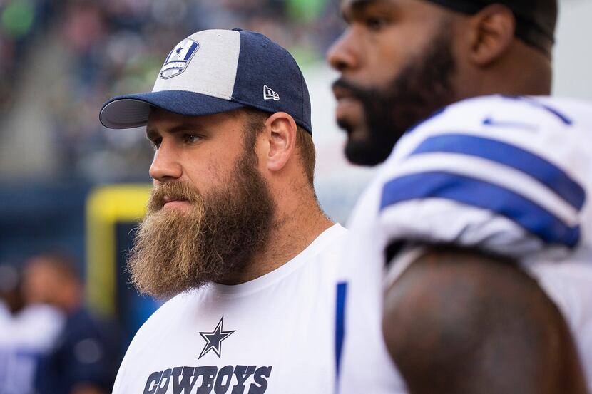 Dallas Cowboys center Travis Frederick watches the game from the bench during the second...