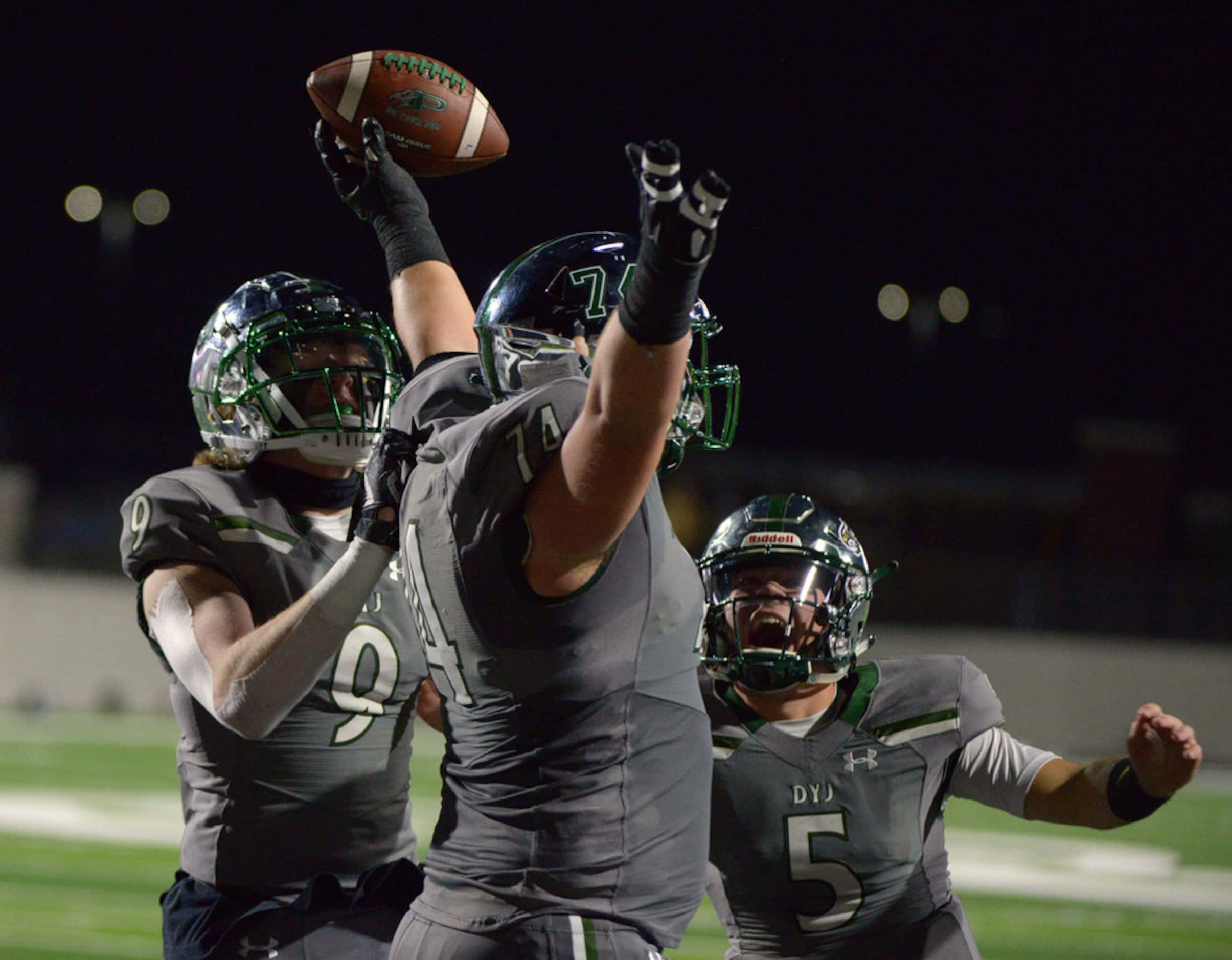 Prosper's Jake Majors (center) celebrates a touchdown reception with teammates Cameron...