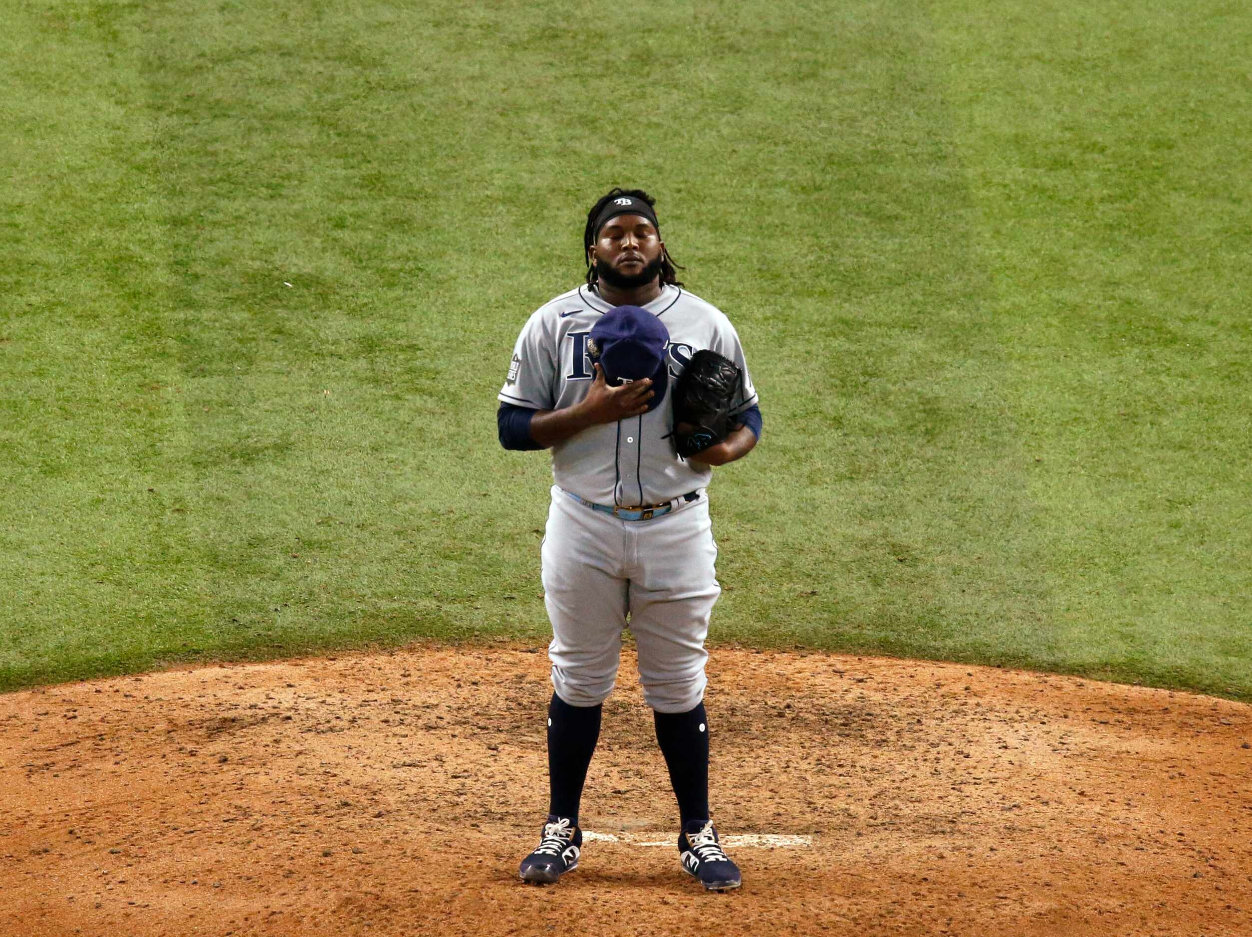 Tampa Bay Rays relief pitcher Diego Castillo (63) takes a moment before pitching to Los...