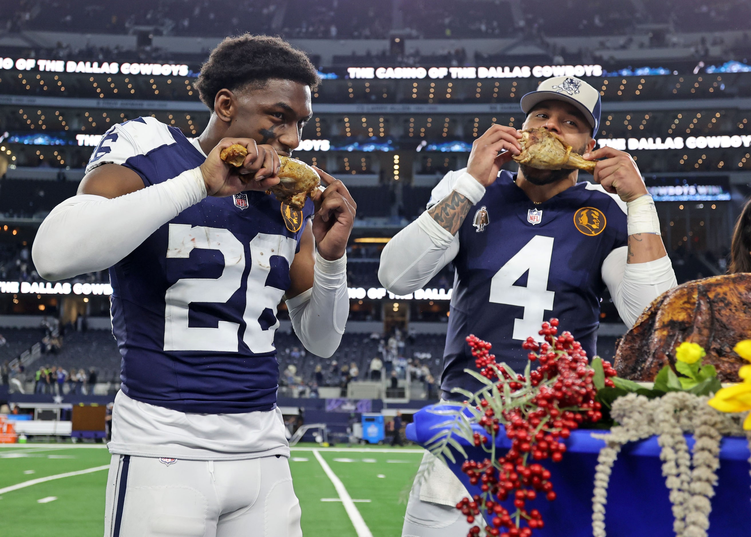 Dallas Cowboys cornerback DaRon Bland (26) and quarterback Dak Prescott (4) feast on turkey...