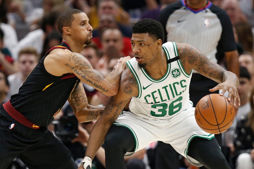 Boston Celtics' Marcus Smart (36) drives past Cleveland Cavaliers' George Hill (3) during...