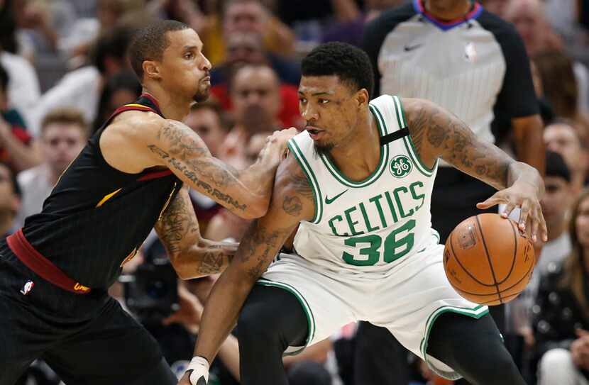 Boston Celtics' Marcus Smart (36) drives past Cleveland Cavaliers' George Hill (3) during...