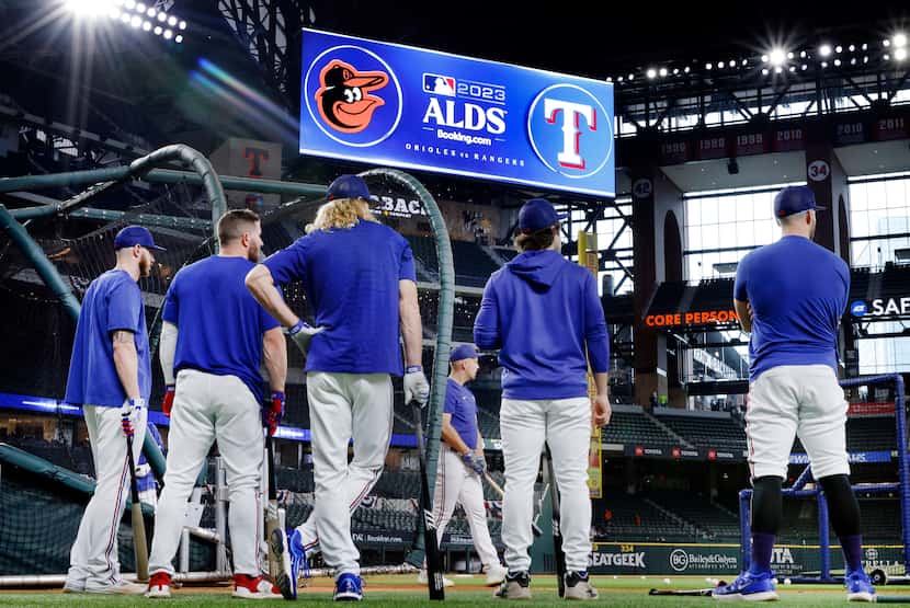 Texas Rangers players take turns during batting practice before they face the Baltimore...