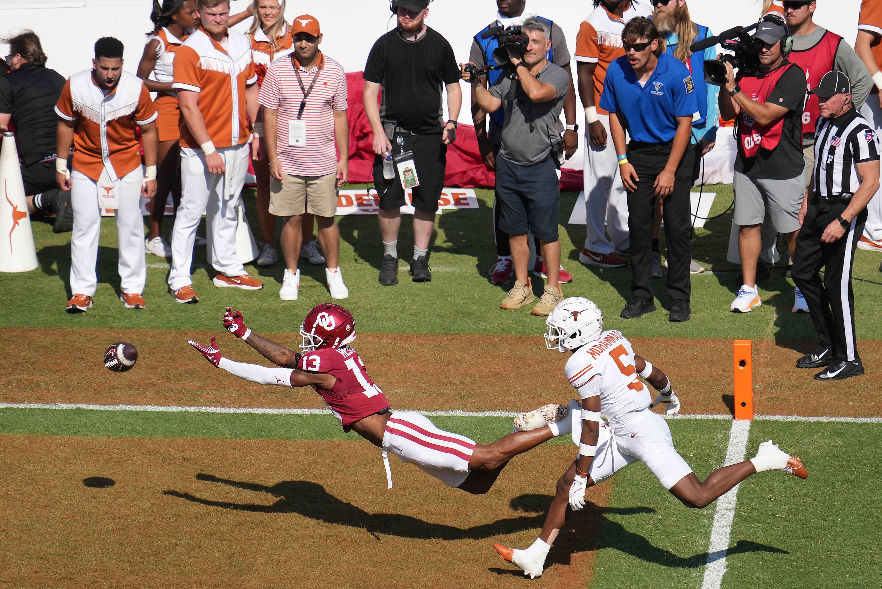 A pass in the end zone goes out of reach for Oklahoma wide receiver J.J. Hester (13) as...