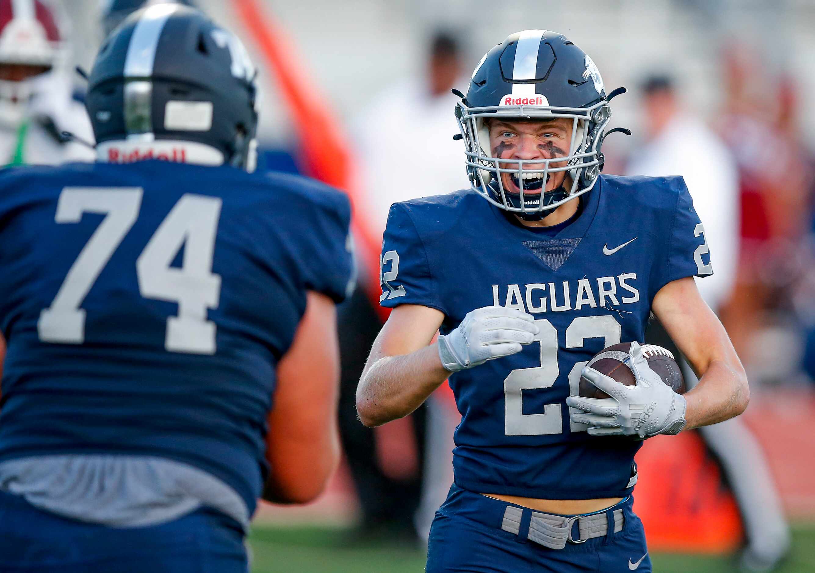 Flower Mound senior running back Cole Smith (22) is congratulated by senior offensive...