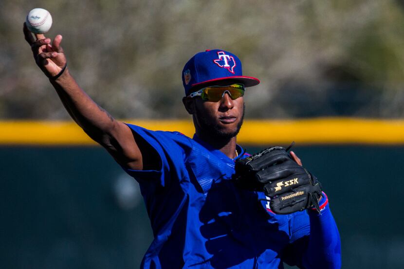 Texas Rangers third baseman Jurickson Profar (19) throws a ball to home base during a spring...