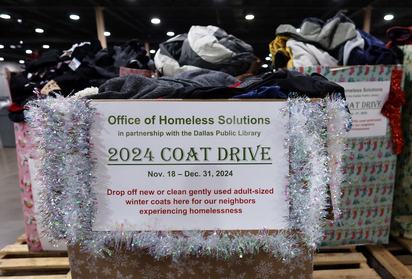 Large boxes are filled with winter coats donated during a holiday drive which will be...