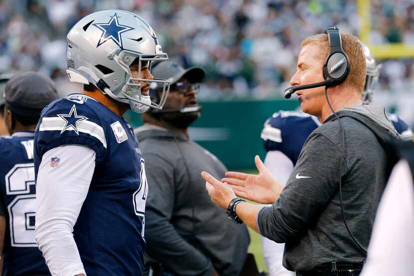 Dallas Cowboys head coach Jason Garrett confers with quarterback Dak Prescott (4) before he...