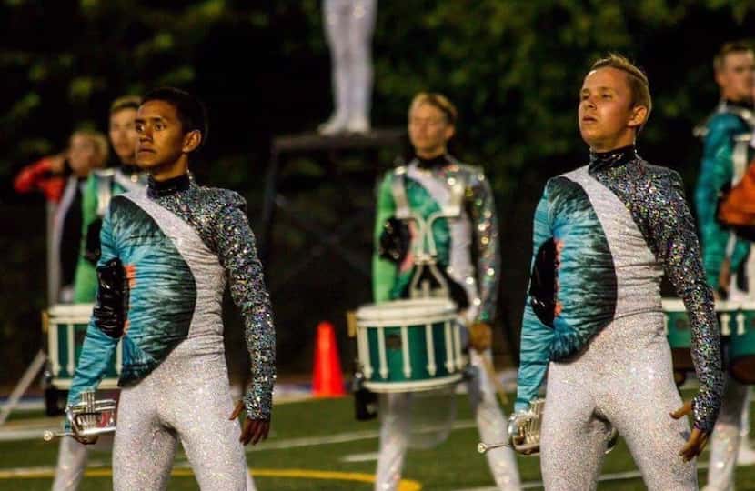 David Johnson (right) performs with the Blue Knights in uniform. 