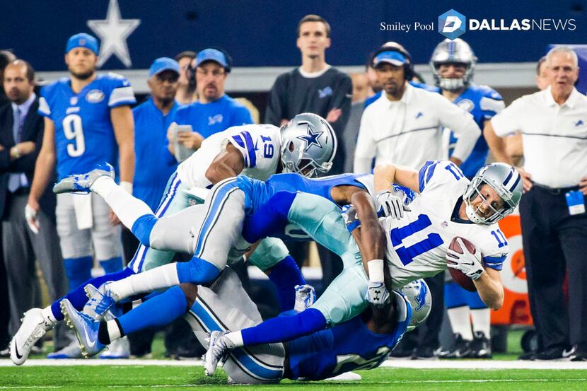 Dallas Cowboys wide receiver Cole Beasley (11) is brought down by the Detroit Lions defense...