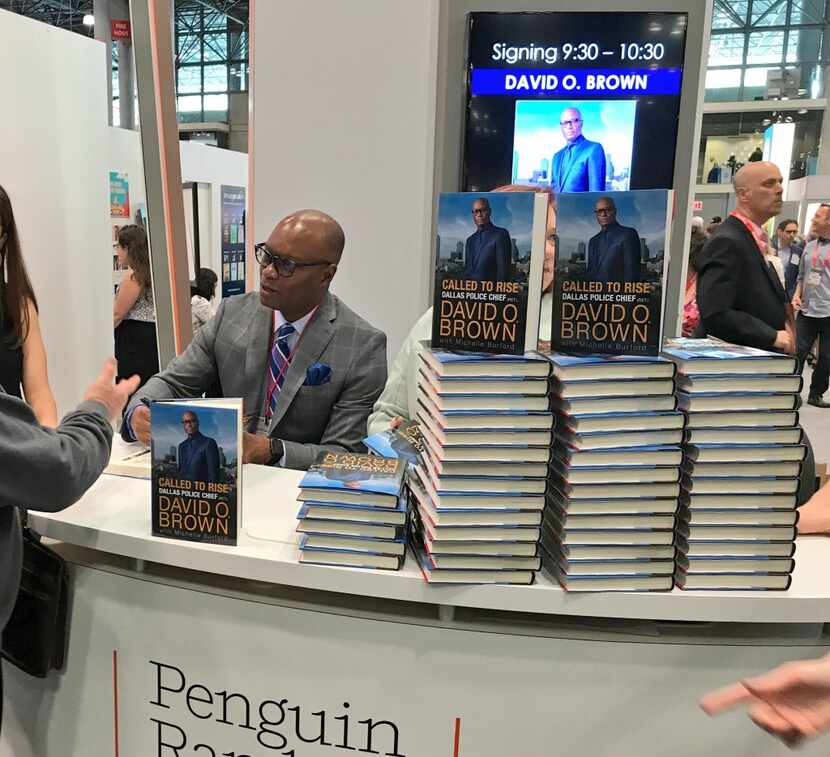 Former Dallas Police Chief David Brown signs his memoir June 1 at Book Expo in New York.