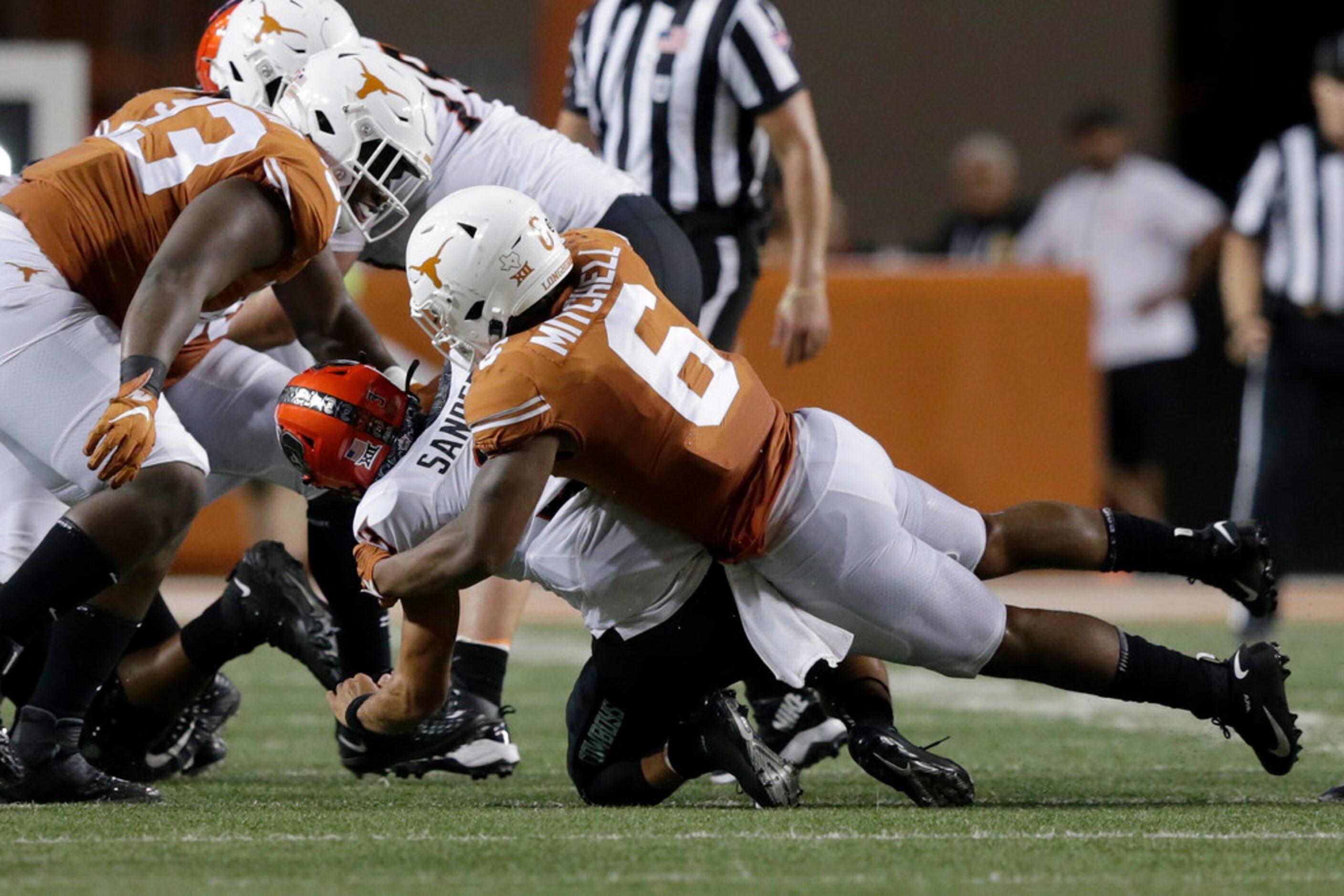 AUSTIN, TX - SEPTEMBER 21:  Juwan Mitchell #6 of the Texas Longhorns sacks Spencer Sanders...