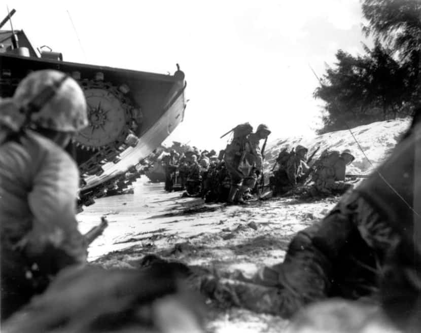 The first wave  of U.S. Marines to hit the shore at Saipan in June 1944 sought cover behind...