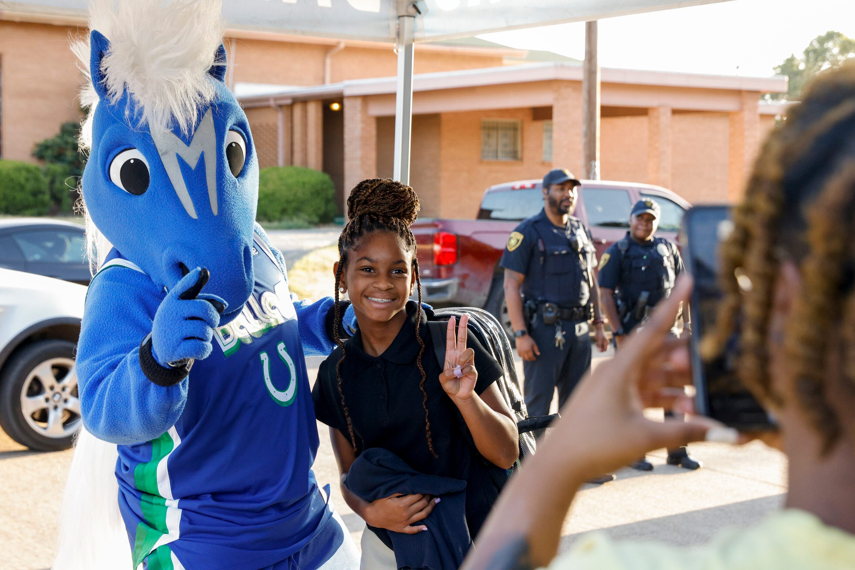 Alajayah Jefferson, 11, poses for a photo with Dallas Mavericks mascot Champ during the Mavs...