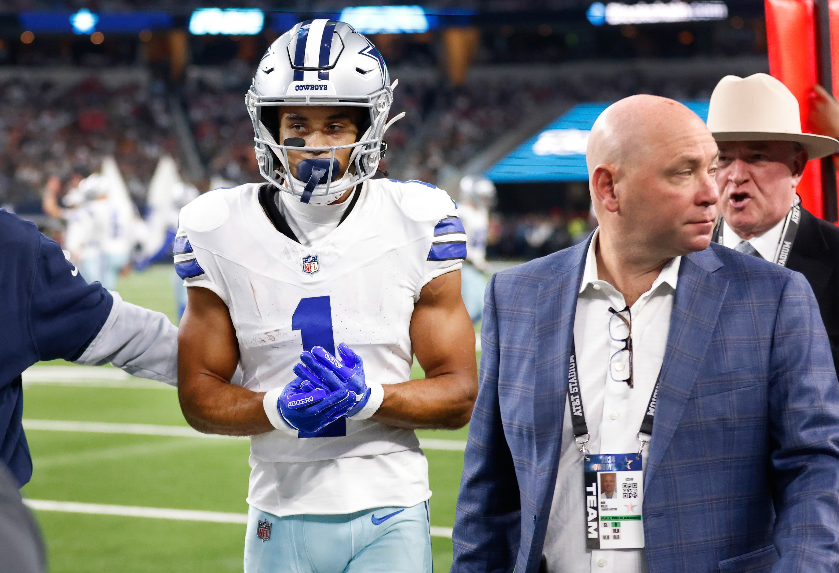 Dallas Cowboys wide receiver Jalen Tolbert (1) holds his injured hand as he heads to the...