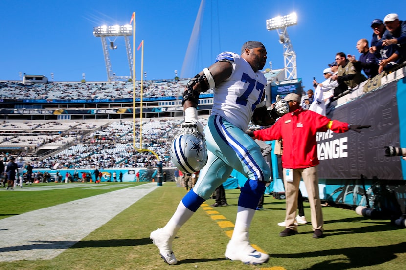 Dallas Cowboys offensive tackle Tyron Smith (77) runs off the field after warming up before...